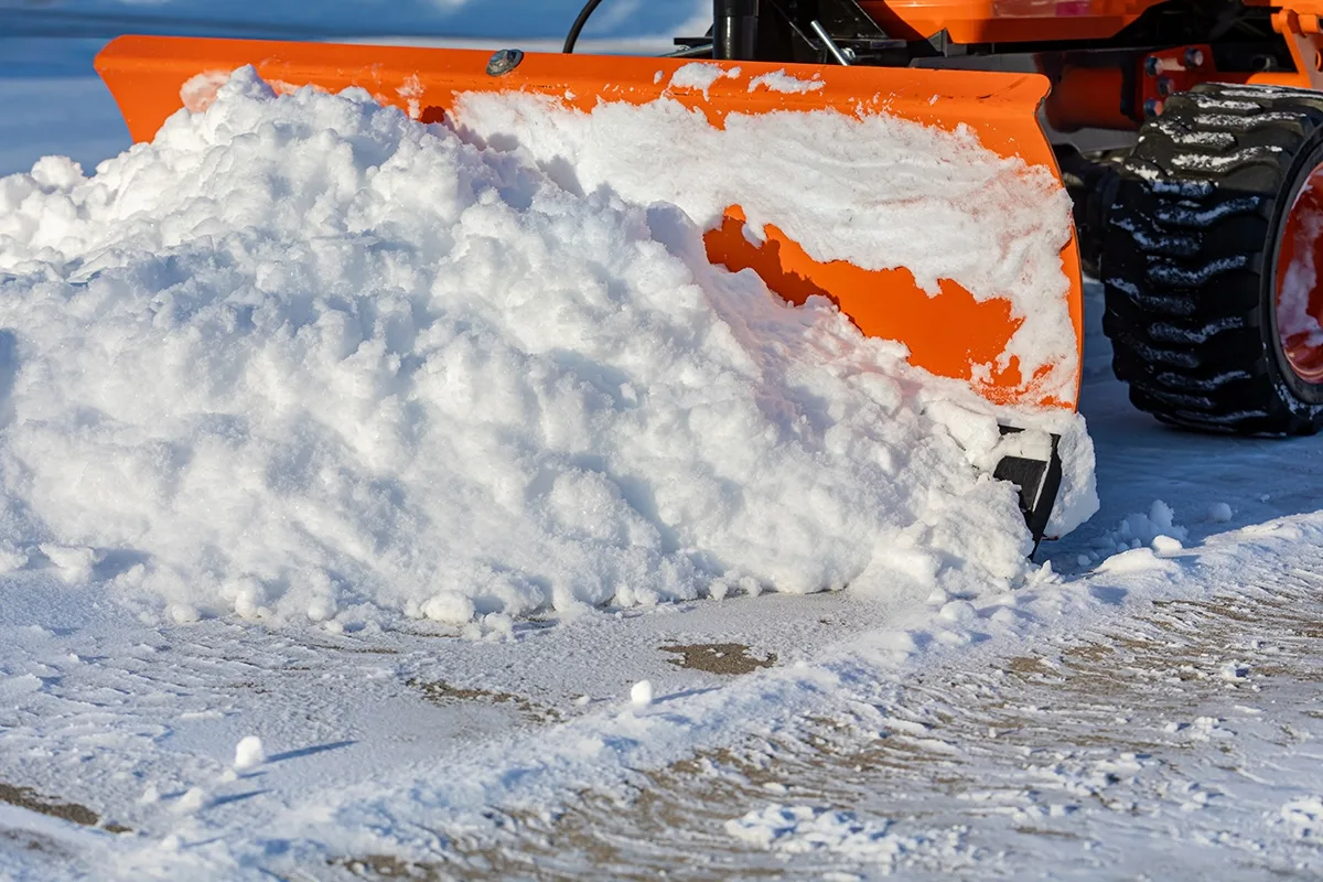 Snow Removal From Driveway With Snowplow. Winter Weather Safety, Home Maintenance, And Snowstorm Concept.